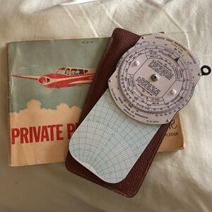 1965 Private Pilot's Handbook and dead reckoning computer with sheath